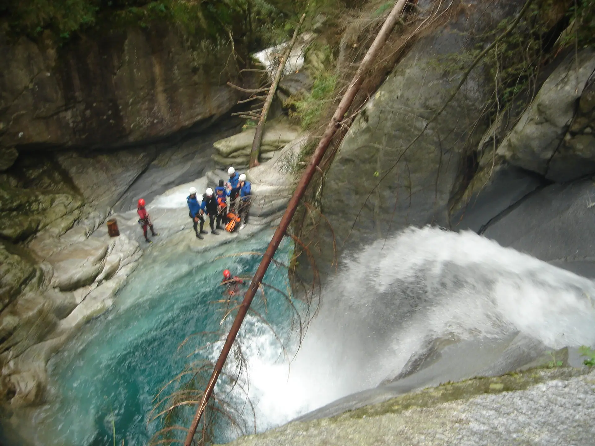 Canyoning-Gruppe an einem Wasserfall in einer Schlucht im Tessin